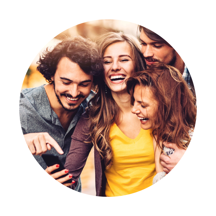 group of friends laughing at something on a smart phone