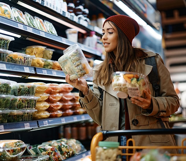 woman shops for prepared foods at grocery store