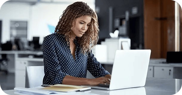 an image of a woman typing on a laptop