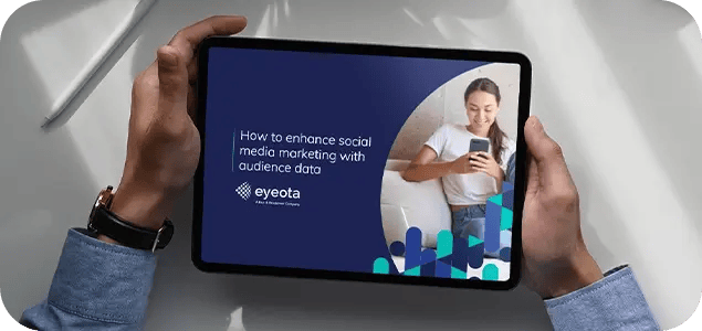 a picture of the Eyeota eBook open on a tablet being held in a person's hands