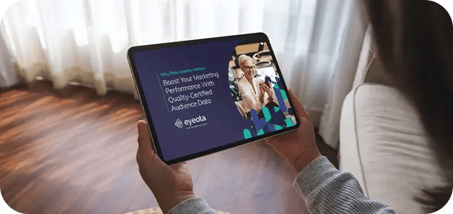 a picture of the Eyeota eBook open on a tablet being held in a person's hands